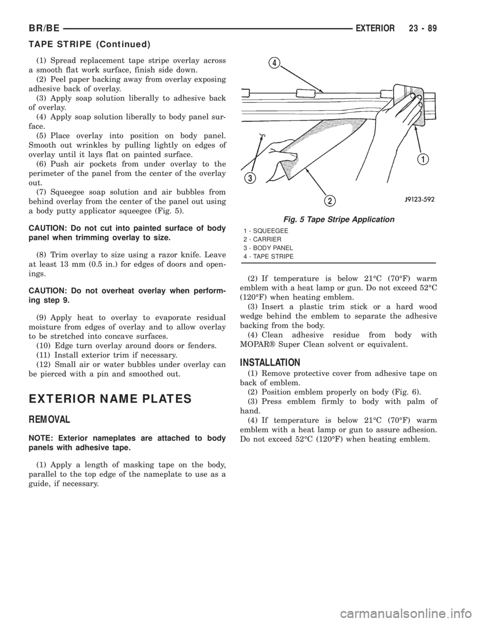 DODGE RAM 2001  Service Repair Manual (1) Spread replacement tape stripe overlay across
a smooth flat work surface, finish side down.
(2) Peel paper backing away from overlay exposing
adhesive back of overlay.
(3) Apply soap solution libe