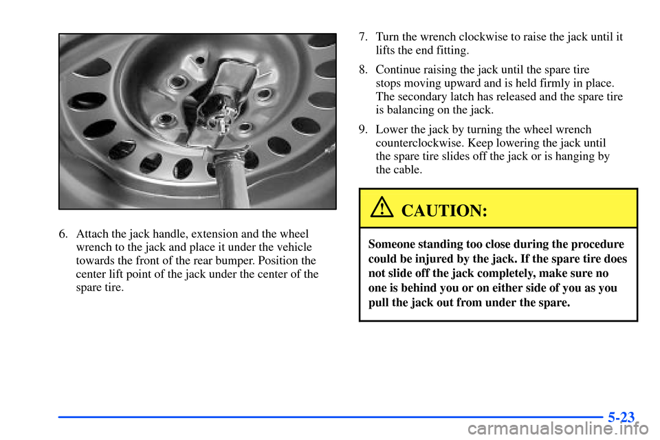 Oldsmobile Bravada 2002  Owners Manuals 5-23
6. Attach the jack handle, extension and the wheel
wrench to the jack and place it under the vehicle
towards the front of the rear bumper. Position the
center lift point of the jack under the cen