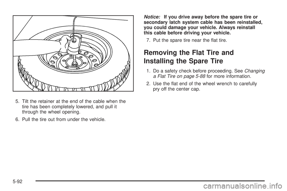 GMC ENVOY 2009  Owners Manual 5. Tilt the retainer at the end of the cable when the
tire has been completely lowered, and pull it
through the wheel opening.
6. Pull the tire out from under the vehicle.Notice:If you drive away befo