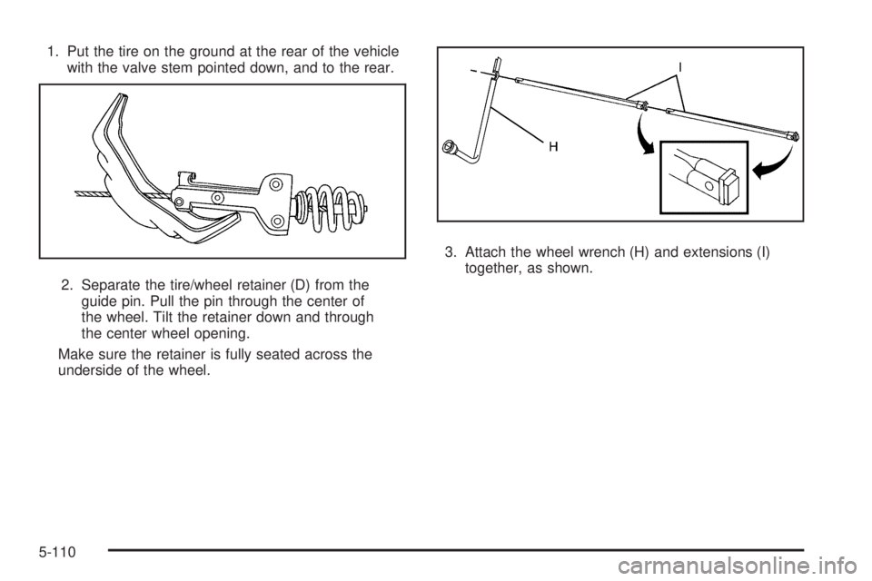 GMC SIERRA 2009  Owners Manual 1. Put the tire on the ground at the rear of the vehicle
with the valve stem pointed down, and to the rear.
2. Separate the tire/wheel retainer (D) from the
guide pin. Pull the pin through the center 