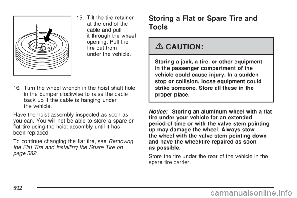 GMC SIERRA 2007  Owners Manual 15. Tilt the tire retainer
at the end of the
cable and pull
it through the wheel
opening. Pull the
tire out from
under the vehicle.
16. Turn the wheel wrench in the hoist shaft hole
in the bumper cloc
