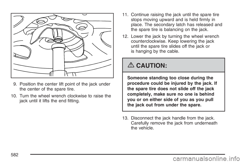 GMC SIERRA CLASSIC 2007  Owners Manual 9. Position the center lift point of the jack under
the center of the spare tire.
10. Turn the wheel wrench clockwise to raise the
jack until it lifts the end �tting.11. Continue raising the jack unti