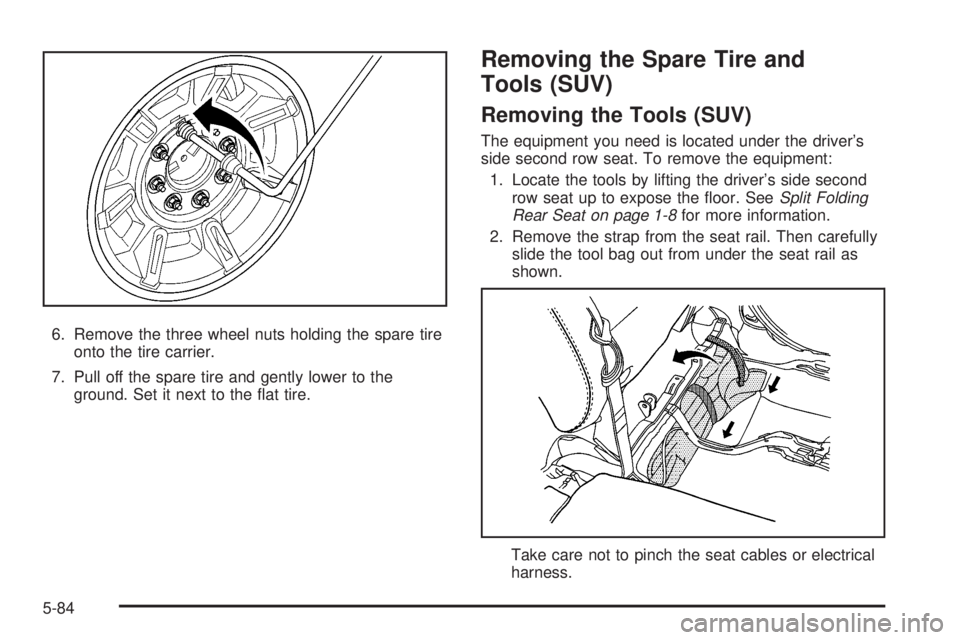 HUMMER H2 2008 Owners Guide 6. Remove the three wheel nuts holding the spare tire
onto the tire carrier.
7. Pull off the spare tire and gently lower to the
ground. Set it next to the �at tire.
Removing the Spare Tire and
Tools (